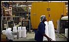 One of the several plastics-based businesses located in the Evansville, Ind., area, Berry Plastics has grown to be one of the biggest since its beginning as Imperial Plastics in 1967. Here, Francis Wilson carries a stack of plastic buckets, on of Berry's products. Denny Simmons / EBJ