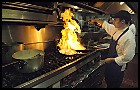 Gamaliel Velazquez heats things up in the kitchen while working at Acroplolis on North Green River Road in Evansville. Jason Clark / EBJ