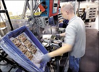 ENGINE GIZMO: Lukas Clifford assembles an engine control module in Plant 8 at Delphi Electronics &amp; Safety. Kokomo Tribine file photo