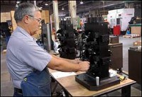 Gary Seward of Ahaus Toolworks with a machinery holding fixture Thursday morning. One of Ahaus' customers is already a supplier to Honda and company president Rick Ahaus hopes to get more business. Palladium-Item photo by Steve Koger
