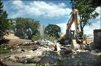 Property demolition continues Monday for Harrison Square; groundbreaking on the massive project is expected this fall. Dean Musser Jr./The Journal Gazette