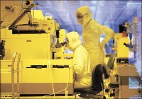 DRESSED IN YELLOW: Fab III employees work in clean suits in a virtually dust-free environment at Delphi Electronics &amp; Safety in Kokomo.&nbsp;KT photo by Tim Bath