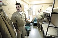 CRAMPED QUARTERS: Offenders Barry Matlock, left, and James Sykes stand in their cell while talking about what life is like living together in a cell originally designed to hold one offender at the Pendleton State Prison in Pendleton.