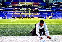 A member of the Super Bowl field crew preps the field at Lucas Oil Stadium Wednesday for its Super Bowl paint scheme. Joseph C. Garza photo