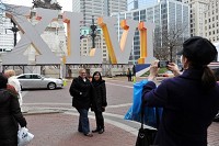 Angela Jorden, left, and Nora Woodman stand in front of the large Super Bowl XLVI display placed on Monument Circle in Downtown Indianapolis as Karen Evans of Greencastle takes a photograph of them on Wednesday. The appearance of Downtown Indianapolis started to change last week as the city prepares to host Super Bowl XLVI on Sunday. Jason Clark, Evansville Courier &amp; Press