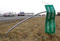 Motorist-mangled highway sign along Interstate 69, near 82nd Street. (IBJ Photo/ Perry Reichanadter)