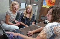 Seeking guidance: From left, Kristy Lemon and her daughter, Abby, a junior, listen as Gwen Braggs, director of guidance, talks with them about Abby's four-year college prep plan Friday at Madison-Grant High School.
