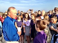 Gov. Mitch Daniels talks with Delphi elementary students at Wednesday's ribbon cutting for the Hoosier Heartland Highway. / Michael Heinz/Journal &amp; Courier