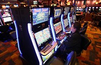 Helen Hernandez, of Calumet City, plays slot machines Monday at the Ameristar Casino in East Chicago. Revenues at Northwest Indiana casinos dropped by $24.3 million in 2012, the second straight year of decline. Staff photo by John Luke