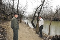 Mounds State Park property manager Ted Tapp and assistant manager Dustin Clark walk along a trail that would possibly be affected by the proposed Mounds Lake Reservoir. Staff photo by John P. Cleary