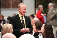 Purdue University President and former Indiana Gov. Mitch Daniels talks with guests at a meeting of the Purdue Alumni Association at Kye's in Jeffersonville on Tuesday night. Staff photo by C.E. Branham