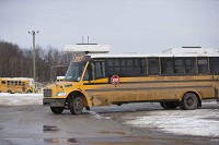 An Elkhart schools bus leaves the transportation center on Wednesday afternoon. In an effort to compensate for reduced funding in transportation caused by tax caps, the district has pushed out its walk boundaries to two miles and lengthened the elementary school day. Staff photo by Santiago Flores
