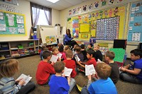 Elizabeth Levrio reads with her kindergarten class at Hebron Elementary School. Part of the Common Core curriculum is a 90-minute block of undisturbed reading time. Staff photo by Dan Shelton