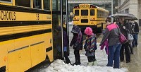 Cathie Rowand | The Journal Gazette: Kids board school buses Thursday after attending a performance at the Embassy Theatre. Area districts are concerned that they may not have enough money to replace and maintain buses, and some are considering suspending service.