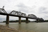The Ohio River flows beneath the K&amp;I Bridge on Wednesday afternoon. Officials on both sides of the river support reopening the bridge to the public, but Norfolk Southern, the transportation company that owns the bridge, is keeping it limited to railway traffic due to liability issues. Staff photo by Christopher Fryer