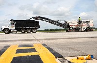 An asphalt milling machine is taken down Grissom's taxiway A, grinding up old asphalt. The runway has been closed since June 1. Kelly Lafferty | Kokomo Tribune
