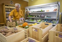 Dave Olive, of Granger, picks out produce Wednesday at Purple Porch Co-op in South Bend. The co-op used Kickstarter, a donation-based model of crowdfunding, to help raise capital for its brick and mortar store, which opened earlier this year. A new law went into effect Tuesday in Indiana that will allow businesses&nbsp; to utilize Internet-based equity crowdfunding. (SBT Photo/ROBERT FRANKLIN)