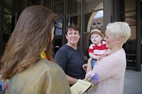 Kim Deckard, left, and Amanda Biggs, right, hold their son Max Deckard-Biggs, as they are married on the steps of the Monroe County Justice Building by Reverend Mary Ann Macklin. A federal judge struck down the Indiana gay marriage ban. The ruling made gay weddings legal in Indiana. Staff photo by Jeremy Hogan