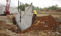 A worker helps build a mechanically stabilized wall where I-69 will cross Bolin Lane along I-69&rsquo;s Section 4. Staff photo Jeremy Hogan