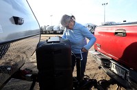 Lola Boles, who has been transporting RVs since 1994, prepares a hitch in April before driving an RV to a dealership in San Antonio from the staging lot at MDZ Trucking in Shipshewana. (SBT File photo/GREG SWIERCZ)