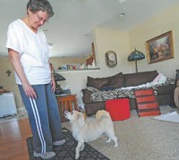 Jean Templeton plays with her dog, Tony, in their apartment at Stonehurst Pointe in Greenfield. More facilities like hers are being planned for Hancock County because of the growing baby boomer population. (Tom Russo / Daily Reporter)