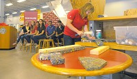 Hammer time: Rose-Hulman&rsquo;s Katie Piens joins three of the manufactured pieces of plastic lumber together with nails as a demonstration of their strength. Staff photo by Jim Avelis