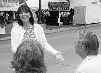 MAKING HER CASE: Republican state treasurer candidate Kelly Mitchell greets a couple attending the Indiana State Fair. Mitchell and other statewide candidates have been visiting the fairgrounds to introduce themselves to voters in advance of the November election. Maureen Hayden photo