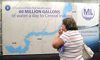 Bonnie Cox of Chesterfield studies the large map of the proposed Mounds Lake Reservoir on Tuesday at Mounds Mall at the first of several public sessions being held in Anderson, Chesterfield, Daleville and Yorktown. The proposed lake would run from Anderson to Yorktown along White River. Staff photo by John P. Cleary