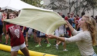 Haley Pierson, left, and Olivia Morris play water balloon volleyball in the aquatics area during RecFest Friday at Indiana University. Staff photo By Jeremy Hogan