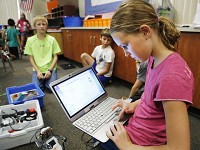 Fifth grade student Elizabeth Ricks uses a laptop computer to program a LEGO robot Friday, August 22, 2014, in Beau Scott's 4/5 high ability classroom at Dayton Elementary School. Scott has a "transparent classroom" where he keeps a blog to keep parents and students updated on what is happening in his class. Staff photo by John Terhune