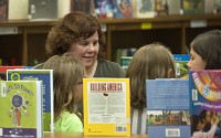 Mary D'Eliso works with students at the University&nbsp; Elementary library in Bloomington. Staff photo by David Snodgress