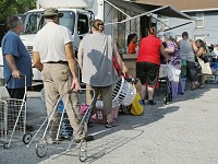 Toting baskets or bags, or even pulling carts, people line up Saturday for free food at the mobile pantry provided by Food Finders Food Bank in the Journal &amp; Courier parking lot at Sixth and Ferry streets. &nbsp;(Photo: John Terhune/Journal &amp; Courier )