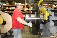Bill Fickle, a setup technician at ABC Metals, prepares to wind metal coils Friday at the facility. Fickle has worked for ABC Metals for 12 years. Staff photo by Sarah Einselen