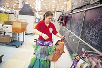 Jamie Kruggel stocks&nbsp;Halloween costumes at Meijer on Indiana 331. Meijer announced last week it would hire about 6,600 people for the holiday season for its stores in Indiana and Michigan. (SBT Photo/SANTIAGO FLORES)