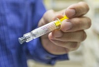 Pharmacist David Snodgraff holds up a pediatric flu vaccine on Monday, Sept. 8, 2014, inside the South Bend Clinic in South Bend. (SBT Photo/ROBERT FRANKLIN)