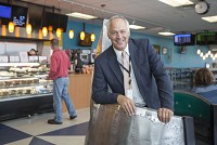 Mark Tarner, president of South Bend Chocolate Co., took over retail operations for the South Bend International Airport&nbsp;in June. He&rsquo;s standing at the hostess stand, which once was a reverse thruster of a military plane. (SBT Photo/ROBERT FRANKLIN)