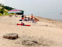 Beach goers compete for bathing spots amid chunks of concrete after erosion along Central Avenue Beach in the Indiana Dunes National Lakeshore. | Carole Carlson~Sun-Times Media