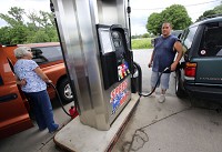 Motorists gas up at the Speed Mart on Ind. 130 earlier this year in Valparaiso. Gas prices in the region and state are starting to come down now that summer is over and the costlier summer blend of gas can yield to the regular blend. Staff photo by John Luke