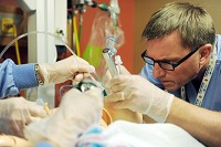 Steve Gruebel, Respatory Therapist, simulates intubating an critical infant who is not breathing as they run a scenario practicing the procedures of resuscitating a baby after delivery during a Nurse Education Day at St. Mary&rsquo;s Medical Center on Tuesday, September 16, 2014. All nurses go through education days throughout the year and about six simulations to keep their skills fresh. Staff photo by Erin McCracken