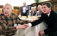 Terry Truitt, dean of the Falls School of Business at Anderson University, talks with Anderson Rotary Club member Bob Shoemaker after outlining details of his 2015 economic&nbsp;forecast Tuesday at Anderson Country Club. Staff photo by Traci Moyer