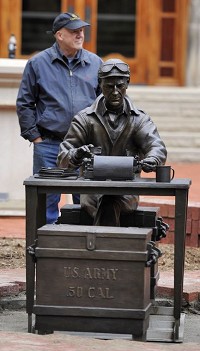 Tuck Langland, sculptor, stands behind his work during the installation of a bronze Ernie Pyle statue outside Franklin Hall at Indiana University in Bloomington, Ind., Thursday, Oct. 9, 2014.&nbsp;Chris Howell | Herald-Times
