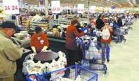 Hustle and bustle: Cashiers check out customers at the Kokomo Meijer store on Nov. 6. Meijer announced in Septmber it was adding 1,800 jobs in Indiana for the holiday season, and the Kokomo store reports it's already added 30 employees. Staff photo by Tim Bath