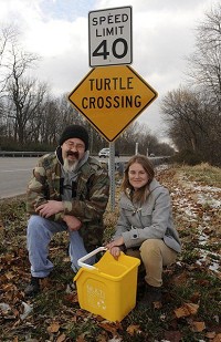 Soft hearts for&nbsp;hard shells: The efforts of Justin Guyer and Amber Slaughterbeck, natural resource programmer for the Vigo County Parks and Recreation Department, helped to have two &ldquo;Turtle Crossing&rdquo; signs installed on National Avenue between Terre Haute and West Terre Haute. Guyer lives in Hutsonville, Ill., and is the president of the Wabash Valley Herpetological Society. Staff photo by Joseph C. Garza