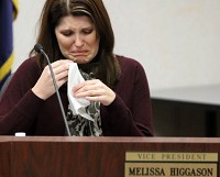 School board Vice President Melissa Higgason is brought to tears as the names of those being laid off are read at a special Munster School Board meeting Thursday. Staff photo by John J. Watkins