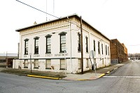 The former New Albany Street Department building is pictured at the corner of Fourth Street and Culbertson Avenue in New Albany on Thursday evening. The site is a city-owned property that could be repurposed into a temporary housing facility. Staff poto by Christopher Fryer