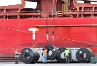 Longshoremen work to unload coils of steel from the hold of the Federal in the Port of Indiana Burns Harbor in April. Finished steel imports captured a record 28 percent market share in 2014, according to preliminary estimates. Staff photo by John Luke