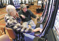 Cindy and Donald Freed of Trafalgar regularly patronize the Indiana Grand casino in Shelbyville. The couple say they'd stop their weekly trips there if state lawmakers force casinos to go smoke-free. Staff photo by Maureen Haydeen