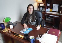 La Porte Mayor Blair Milo sits at her desk with a copy of NIRPC's 2014 Public Participation Plan. Staff photo by Matt Fritz