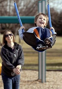 Is Anderson family-friendly? Three year old Grant Bauman was all smiles as mom, Alena Bauman, pushed him higher in the swings at Pulaski Park Wednesday afternoon while they were out enjoying the warm February day. Staff photo by John P. Cleary