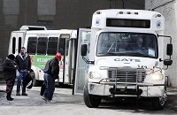 Riders load onto CATS buses at the bus terminal on Friday. In his $31 billion, two-year budget proposal, Gov. Mike Pence asks for a 3 percent cut in mass transit spending. Staff photo by Don Knight